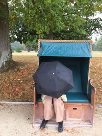 Low section of man sitting on bench