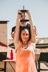 A couple exercising on their rooftop