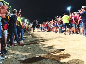 Group of people enjoying music concert at night