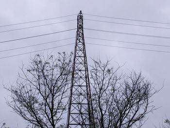 Low angle view of electricity pylon against clear sky