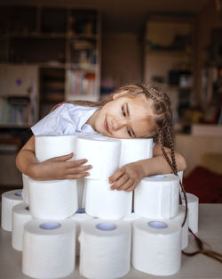 Portrait of smiling girl sitting on table