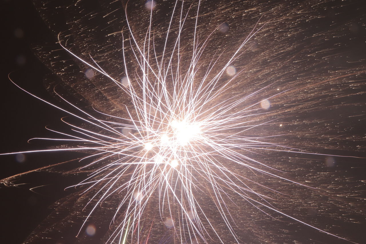 LOW ANGLE VIEW OF FIREWORKS IN SKY AT NIGHT