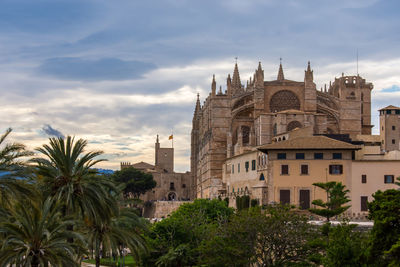 Panoramic view of buildings and trees against sky