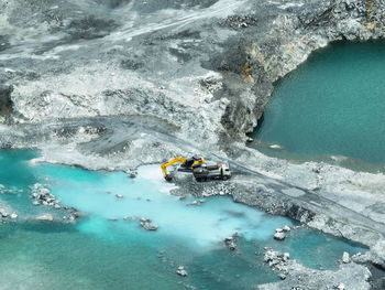 Open pit mine industry. limestone quarry with backhoe and truck in operation. heavy machinery