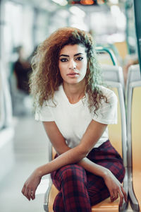 Portrait of young woman sitting in train