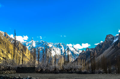 Scenic view of snowcapped mountains against clear blue sky