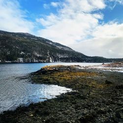 Scenic view of river against sky during winter