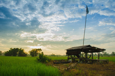 Gazebo on field against sky during sunset