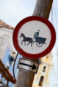 Low angle view of road sign against sky