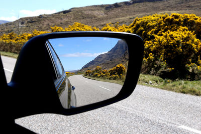 Reflection of car on side-view mirror