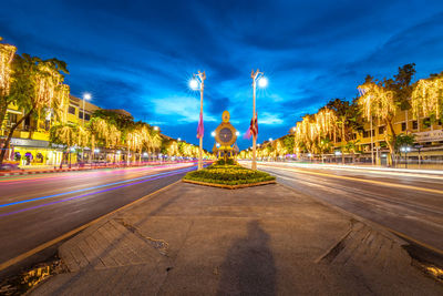 Light trails on road against sky in city