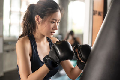 Determined woman boxing at gym