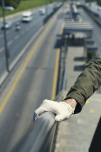 High angle view of hand on road in city
