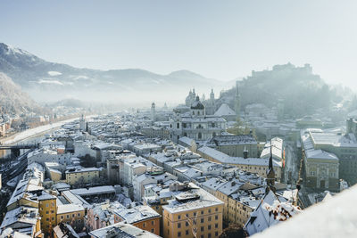 Historic centre of the city of salzburg covered in snow on a beautiful winter day