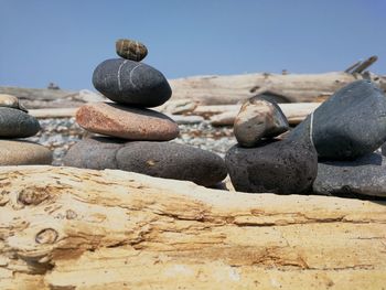 Stack of pebbles on beach against clear sky