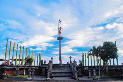 Low angle view of people on staircase against sky