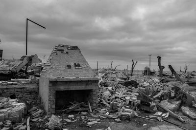 Abandoned built structure on field against sky