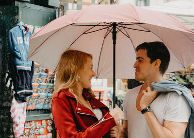 Young couple with umbrella in rain