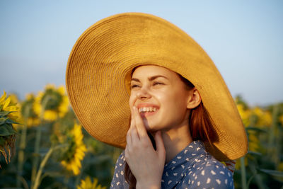 Young woman wearing hat against sky