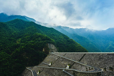 Scenic view of mountains against cloudy sky