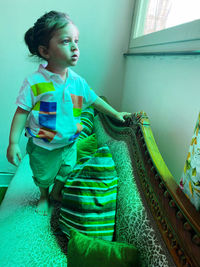 Girl looking away while standing at home