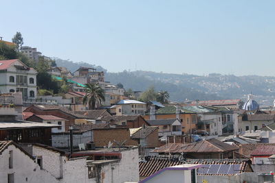 Houses in city against clear sky