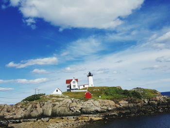 Lighthouse against cloudy sky