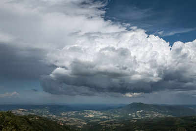 Aerial view of landscape against dramatic sky
