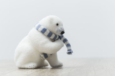 Close-up of toy on snow over white background