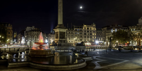 Illuminated trafalgar square against sky at night