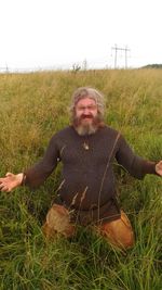 Portrait of man on field against sky