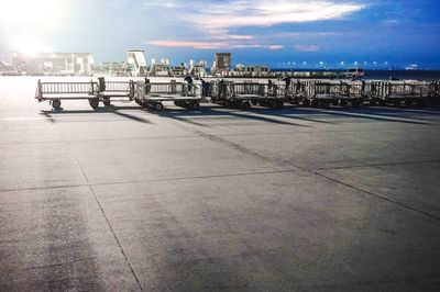 View of airport runway against cloudy sky