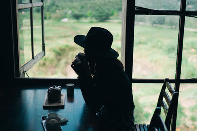 Man photographing through window