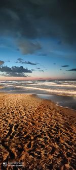 Scenic view of beach against sky during sunset