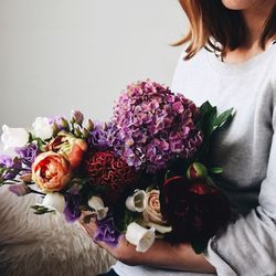 Midsection of woman with bouquet