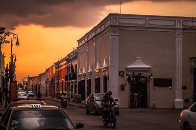 View of city street against cloudy sky