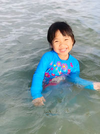 Portrait of girl swimming in sea