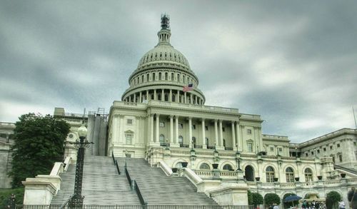 Low angle view of historical building against cloudy sky