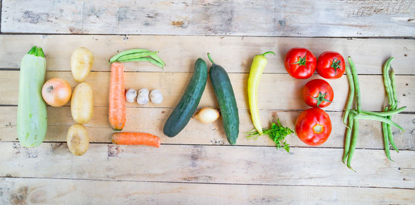 Text made from vegetables on wooden table