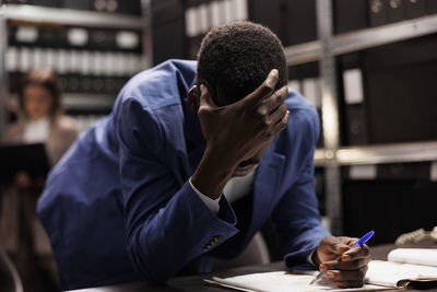 Side view of man working at office