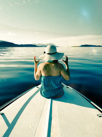 Rear view of woman looking at sea against sky