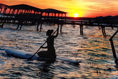 Paddler at sunset on lake waccamaw nc