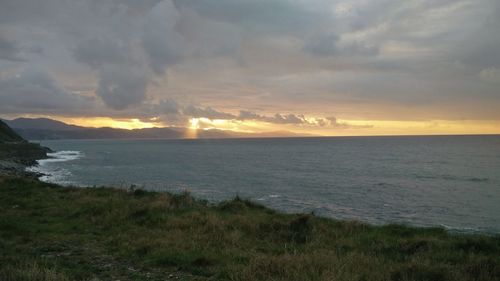 Scenic view of sea against sky at sunset