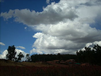 Scenic view of field against cloudy sky