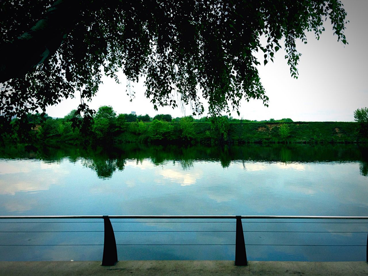 water, lake, tranquility, tranquil scene, reflection, scenics, tree, silhouette, nature, beauty in nature, sky, river, lakeshore, calm, railing, idyllic, outdoors, pier, jetty, tree trunk