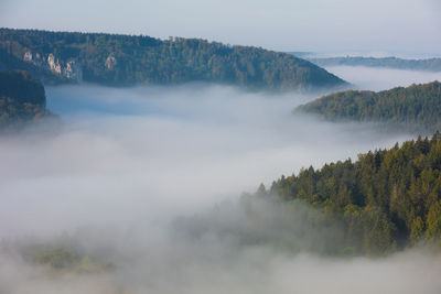 Scenic view of trees and mountains against sky