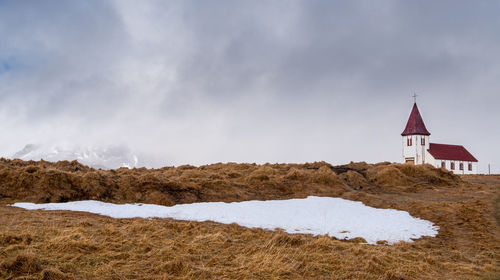 Old church in hellnar with snow on the ground near arnarstapi in iceland