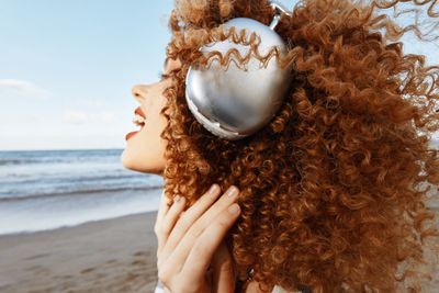 Close-up of woman with eyes closed at beach