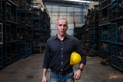 Portrait of man standing in factory