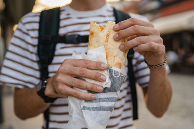 Midsection of man holding food